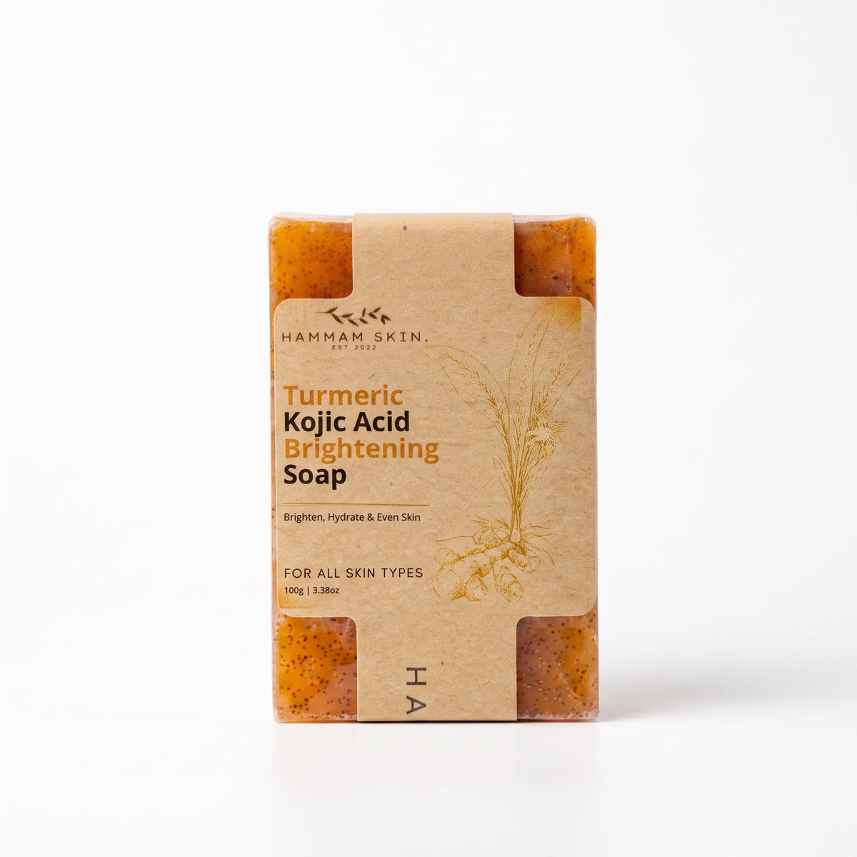Hammam Skin Turmeric Kojic Acid brightening soap bar with exfoliating particles in eco-friendly paper packaging.