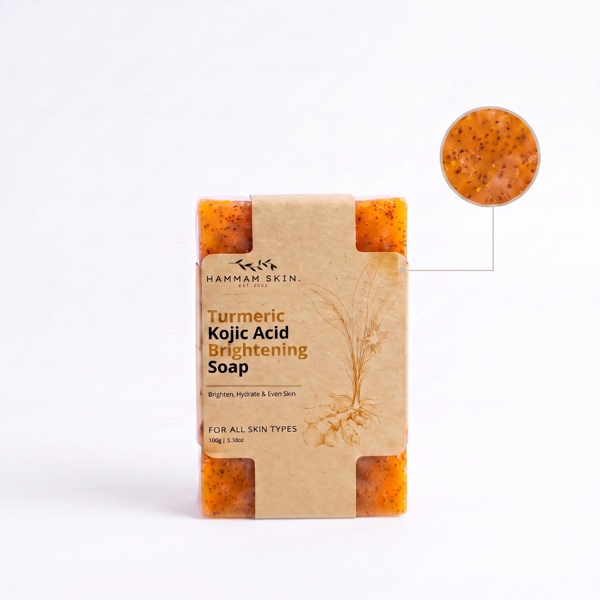 Hammam Skin turmeric and kojic acid brightening soap bar with visible botanical particles in a paper wrapper